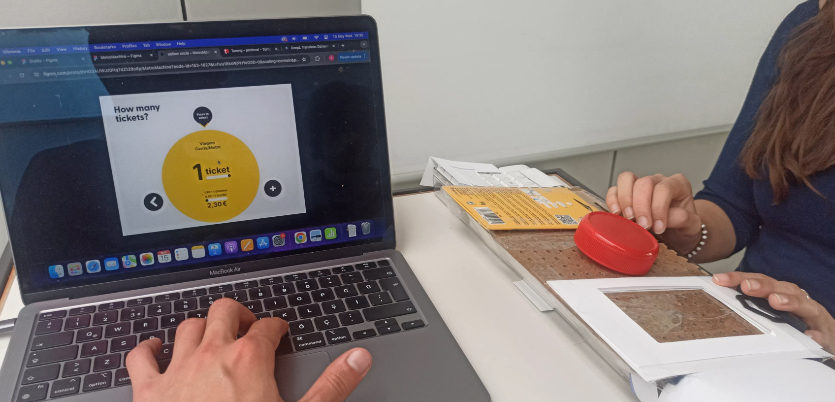 User doing a blind test of the interface. Computer on the front shows the UI for the testing team to follow it.