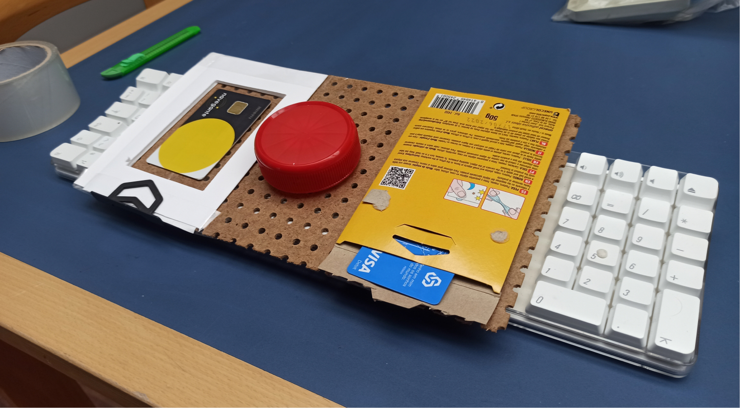 Physical prototype of Option 1, with a rotation wheel in red in the middle and slots to put your card on each side.